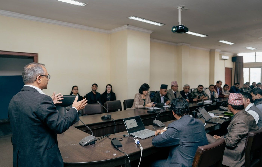 A speaker addressing participants at a National Carbon Registry meeting