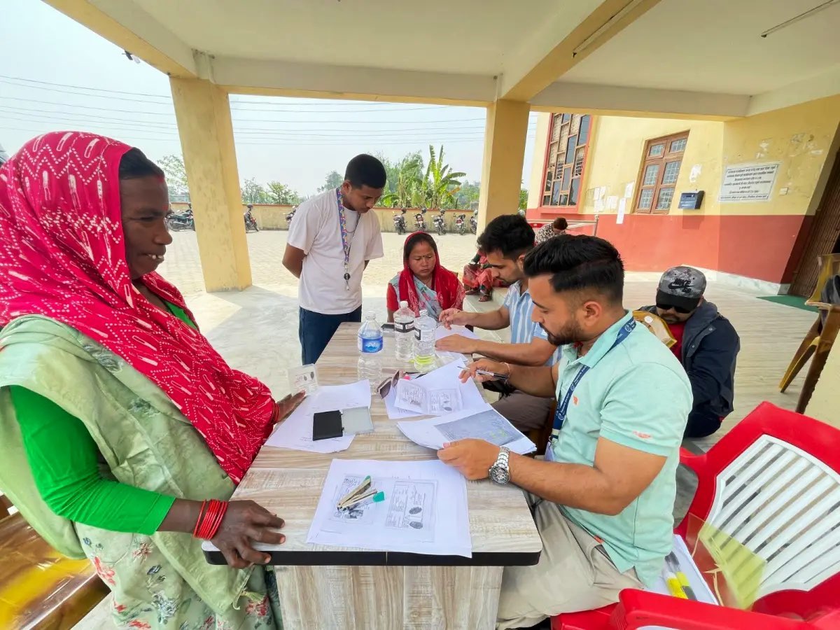A programme participant completing recipient records with the field team